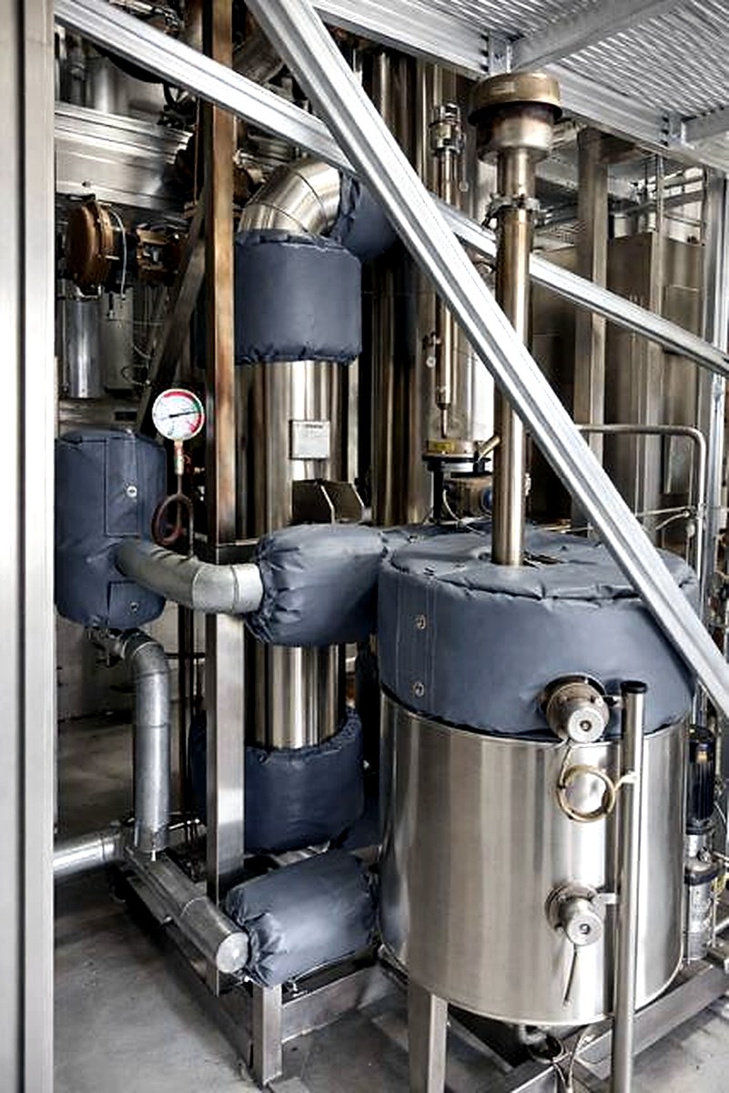 Dark grey thermal jackets on complex process vessel assembly with stainless steel pipework